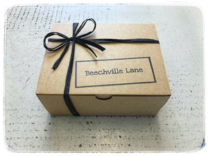 Beechville Lane rustic brown kraft box with black raffia ribbon.